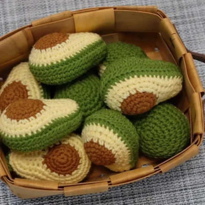 a bunch of crocheted avocados