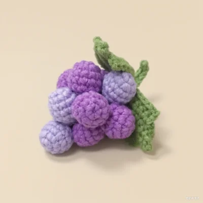 a bunch of crocheted purple grapes