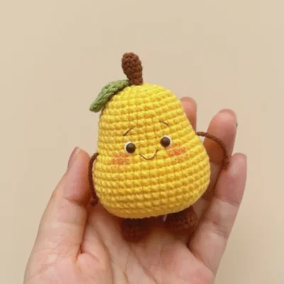 crochet pear on hand