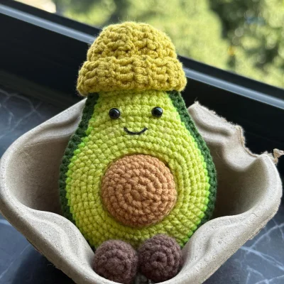 crocheted avocado in a box