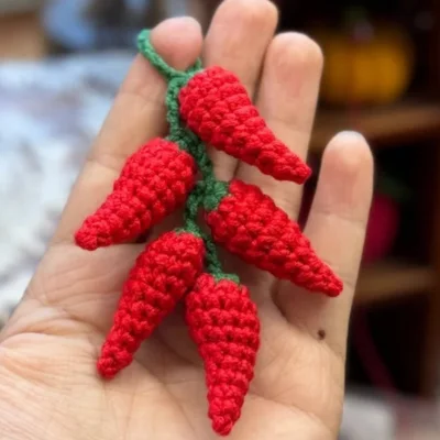 crochet chili peppers in hand