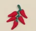crochet chili peppers on light background